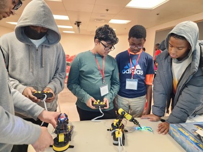 Students testing their robotic arms