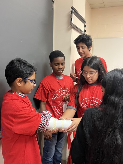 Students working on their robotic arm