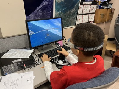 Student using flight simulator in AEL
